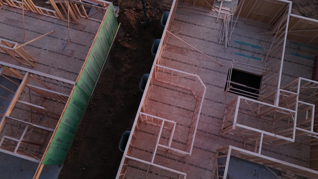 partial view of new house above construction framing